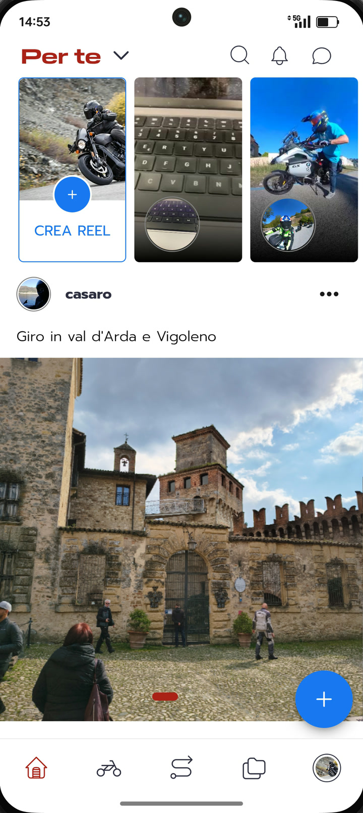 Schermata del feed nell'app: tre reel in alto e sotto il post di un giro in val d'Arda con la foto di un castello